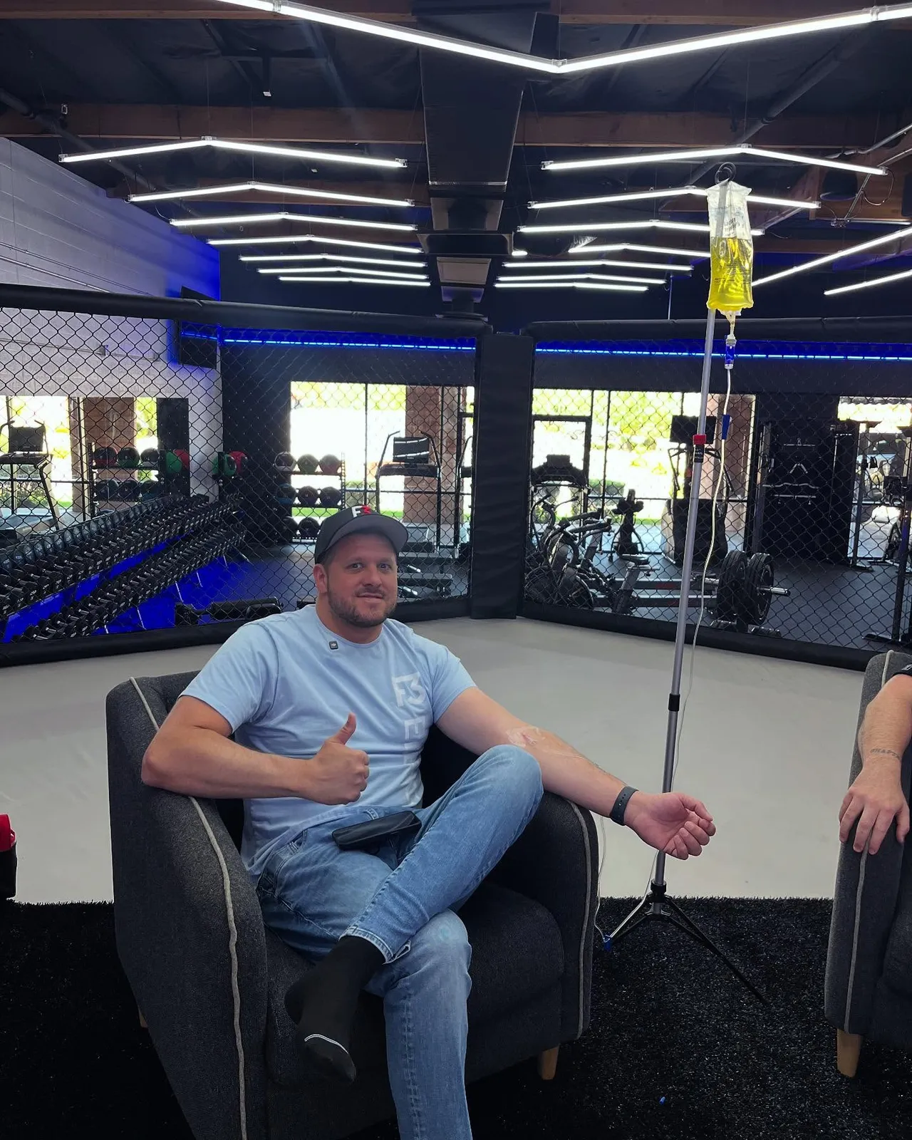A guest giving a thumbs-up with his IV at a sports venue
