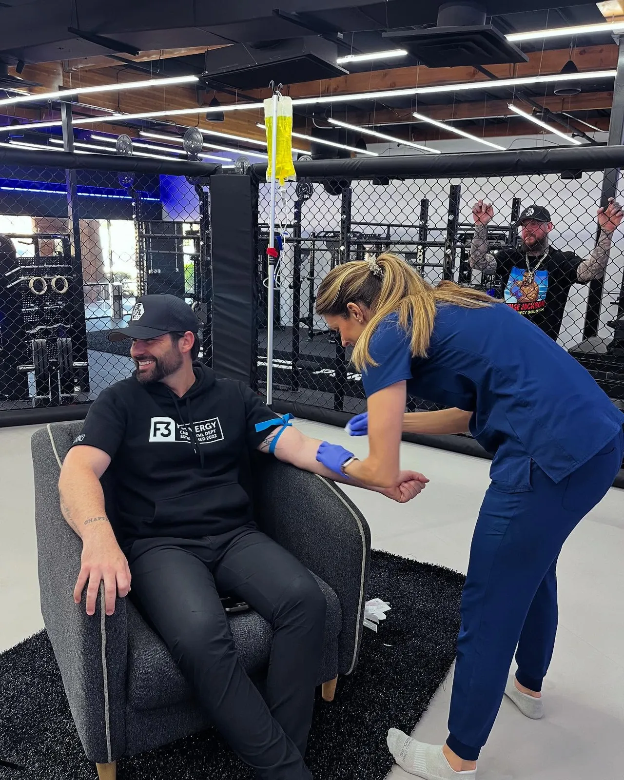A nurse starting an IV for an athlete at a fight night
