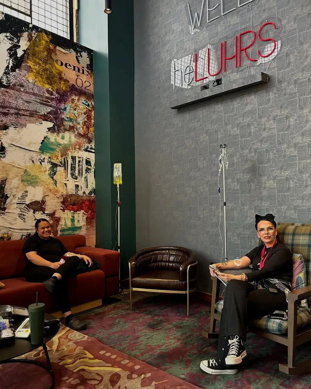 Two guests with their IVs in a hotel lobby lounge