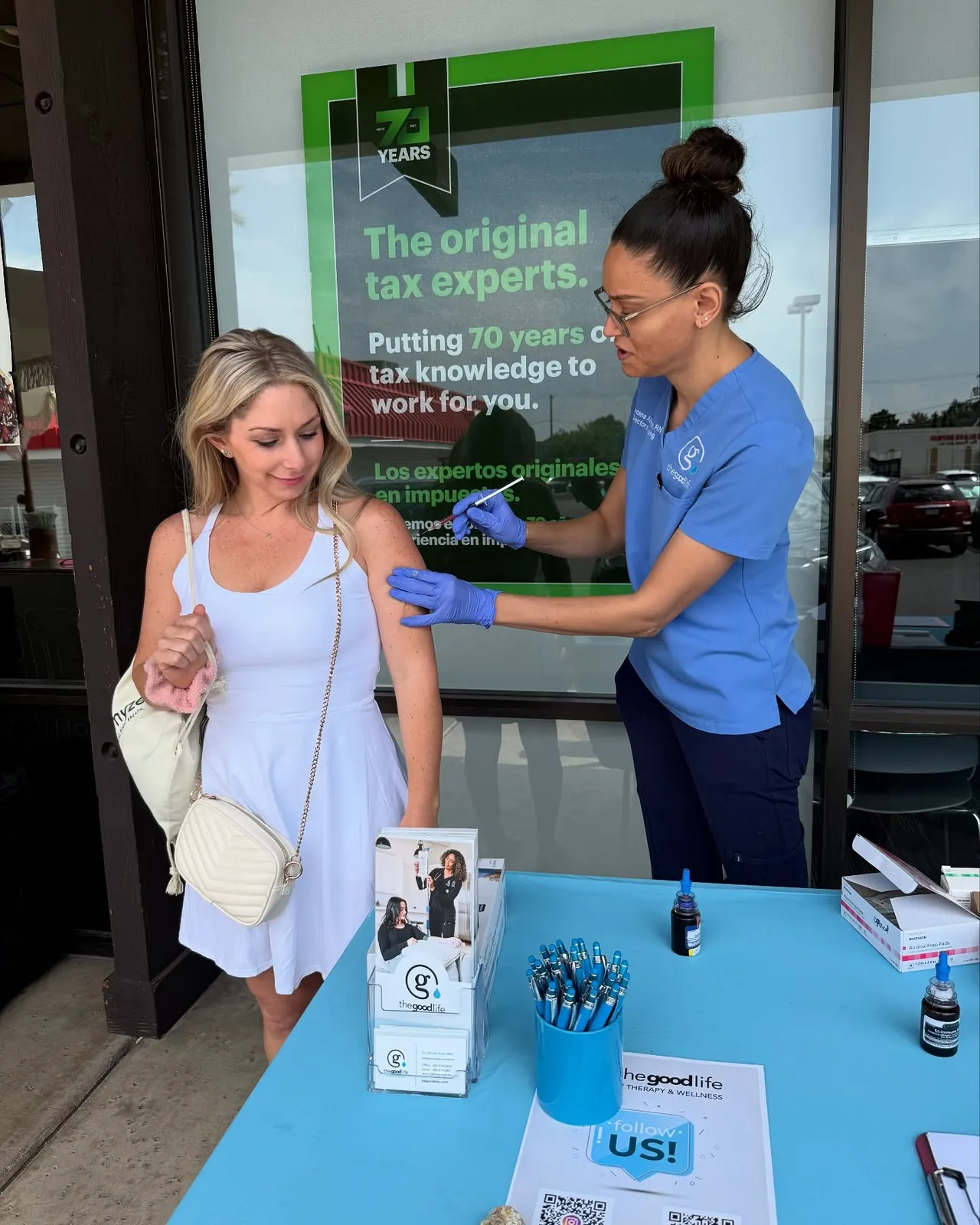 A nurse giving a client an injection at a pop-up