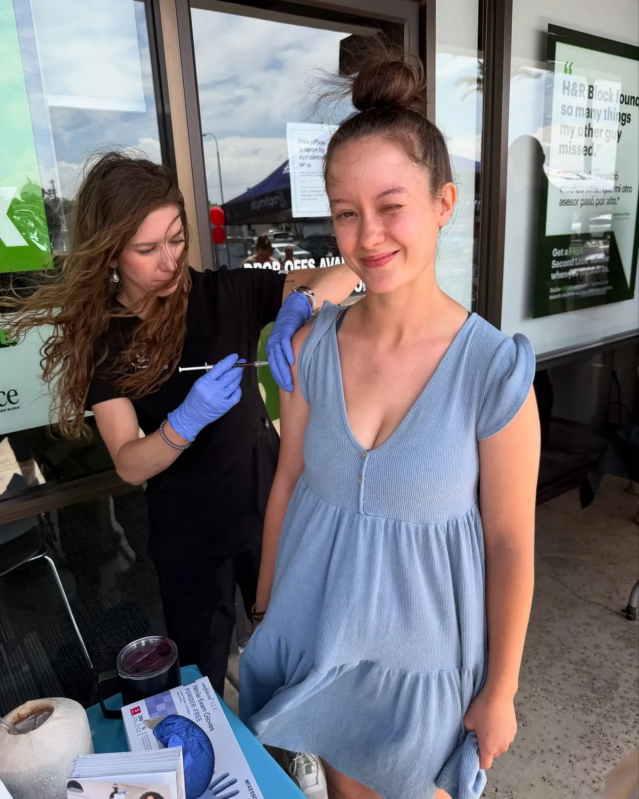 A Good Life nurse giving a client an injection at a pop-up event