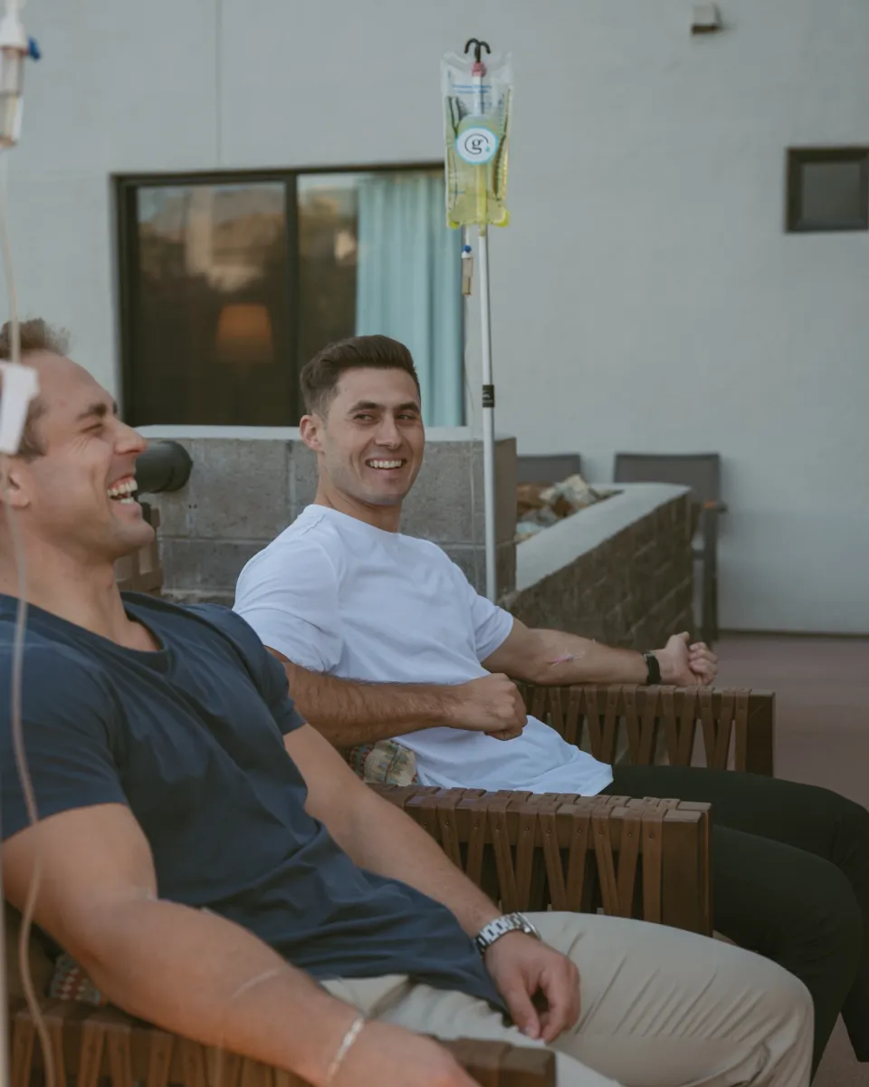 Guests relaxing with their IVs on a patio