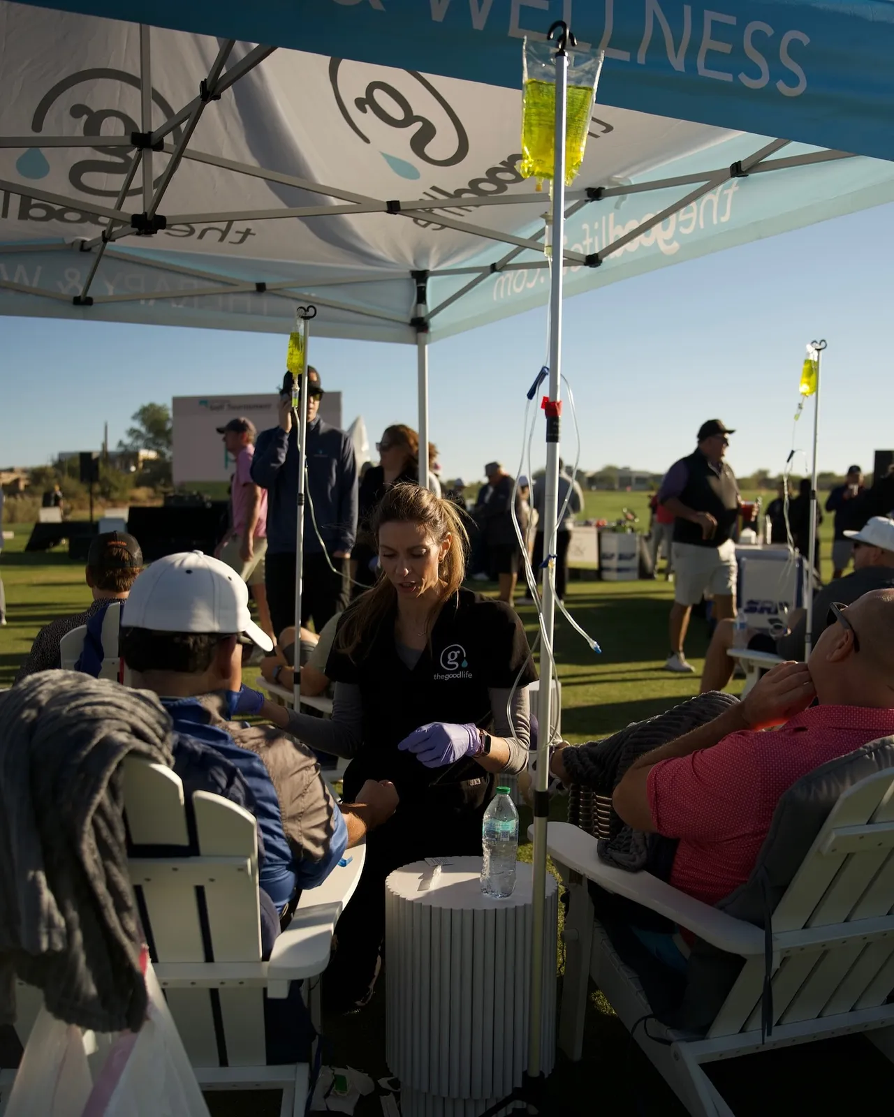 Guests with their IVs under the Good Life tent at a big outdoor event